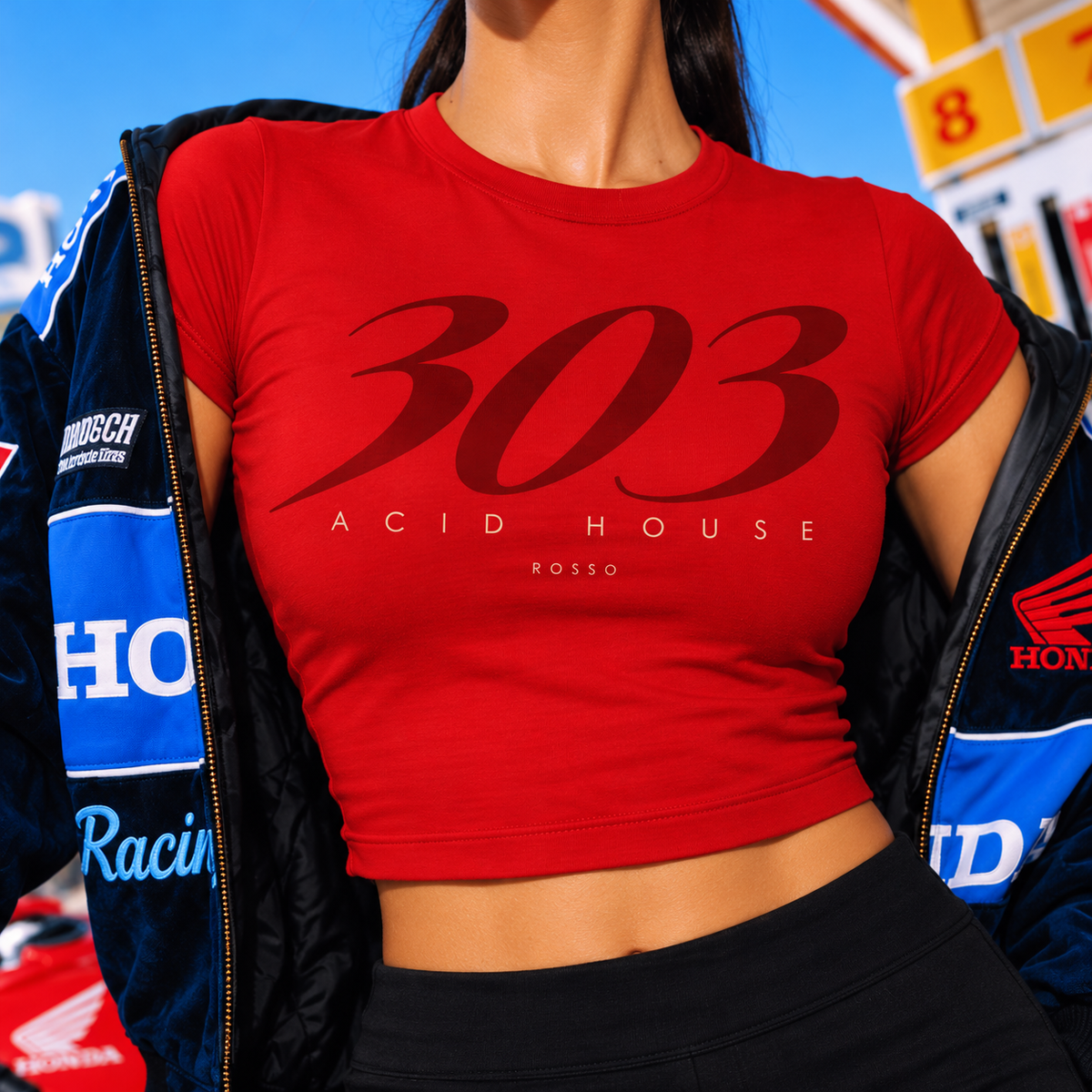 Close-up of Rosso 303 burgundy graphic and ivory Acid House lettering on a red baby tee